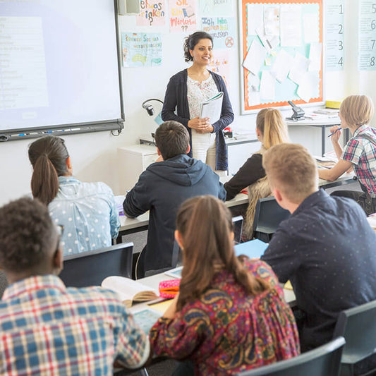 Teacher engaging with students in a classroom, illustrating classroom management and preventing teacher burnout with Love and Logic strategies